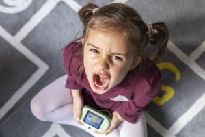 portrait little girl upset because game